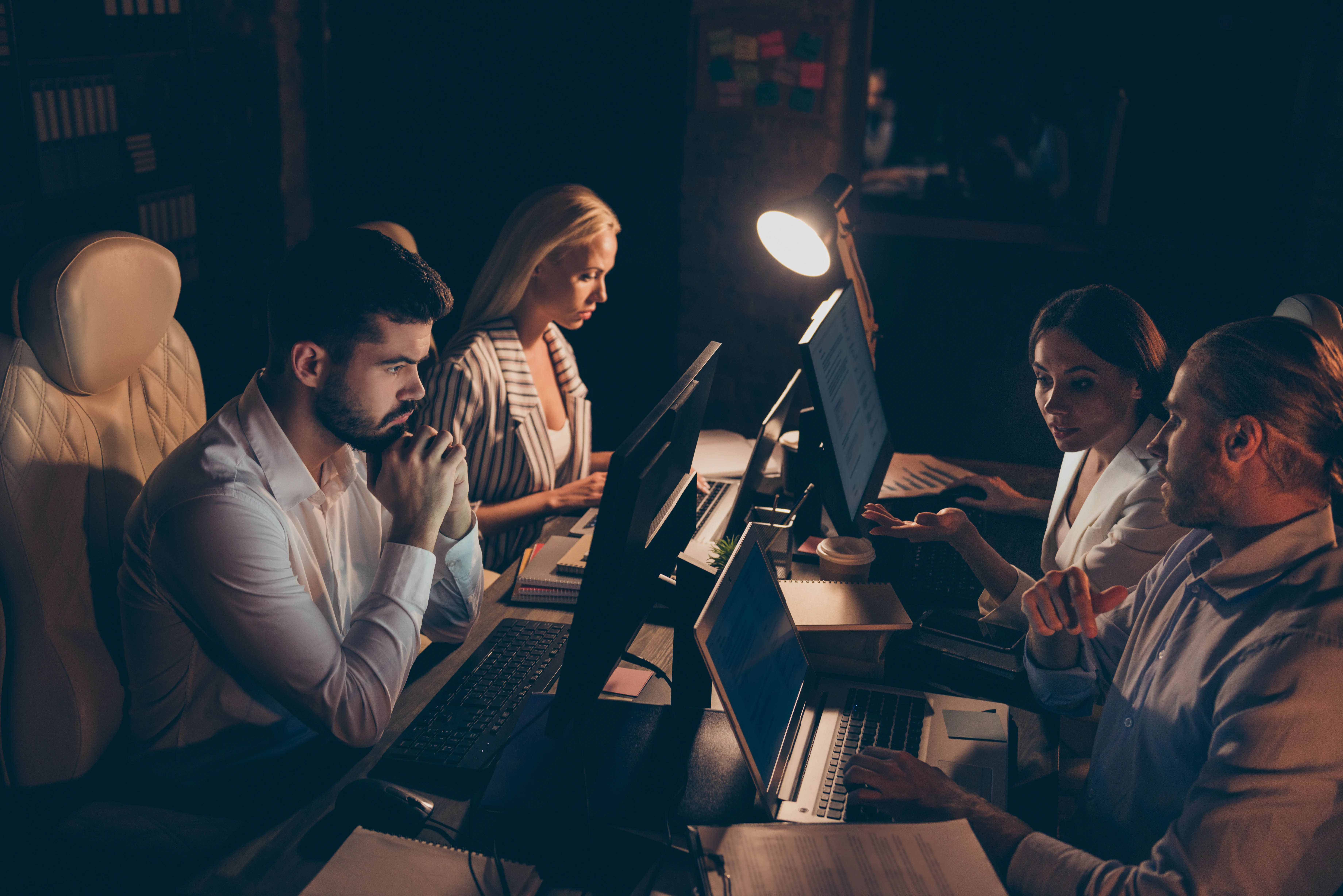 Four legal professionals collaborating in a modern office